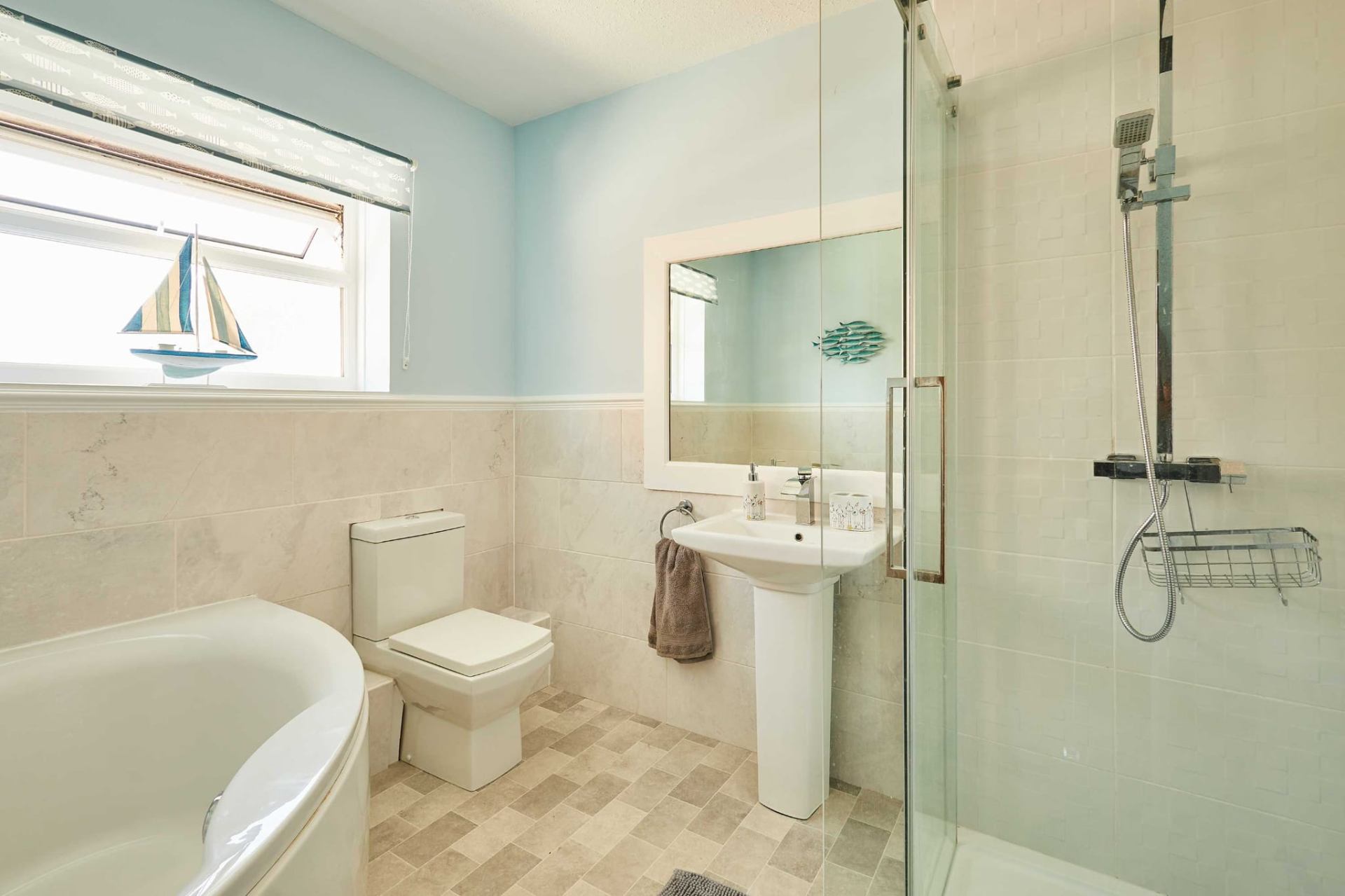 Family bathroom with bath, walk-in shower and seaside touches
