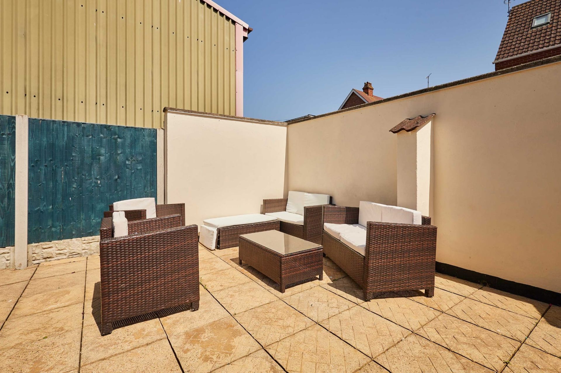 Rattan sofa set on the sun-drenched patio at Sea Breeze