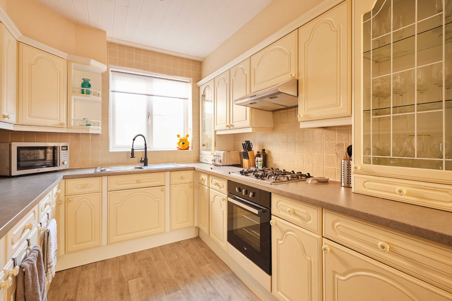 Fully fitted cream kitchen with gas hob, oven and everything for self-catering
