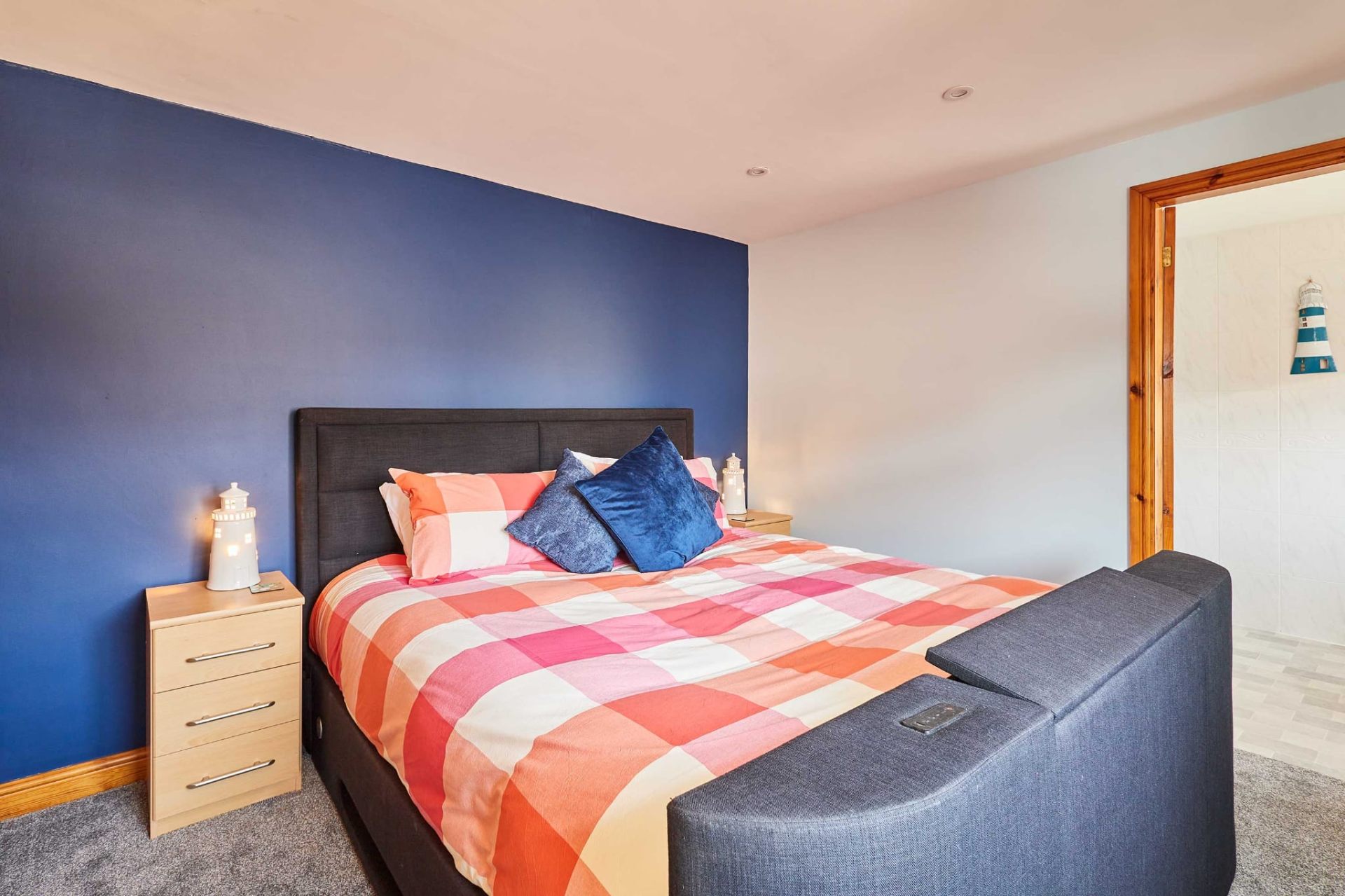 Double bedroom with deep blue feature wall and ensuite bathroom
