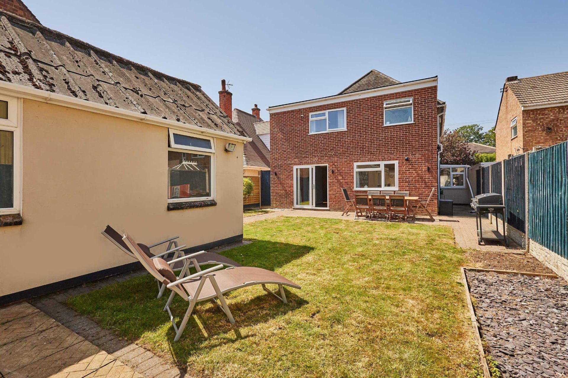 Sunny back garden with lawn, patio and dining set at the Skegness holiday home